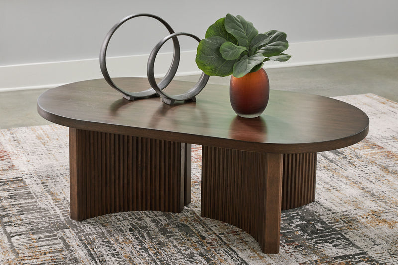 Korestone - Dark Brown - Oval Cocktail Table - JaxCo Furniture
